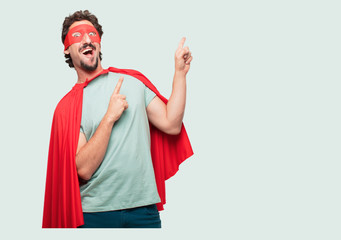 crazy man as a super hero gesturing victory, with a happy, proud and satisfied look on face,...