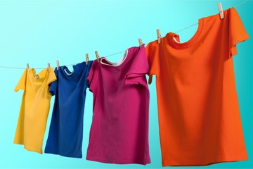Colorful t-shirts hanging on rope
