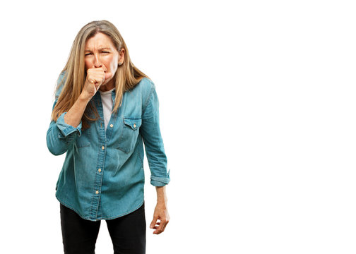 senior beautiful woman Coughing, suffering a winter illness such as a cold or the flu, feeling unwell and feverish.