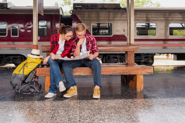 Young traveling backpacker on vacation at the train station, travel concept