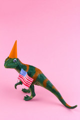 plastic funny green dinosaur with USA flag