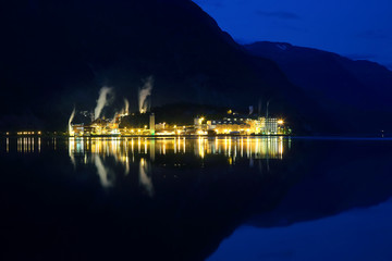 Fototapeta premium Night city Odda in the reflection of water. Norway