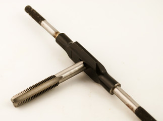 Cutting tool to make thread known as hand tap on white background