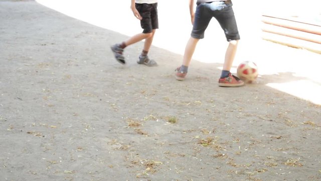 Two kids playing football