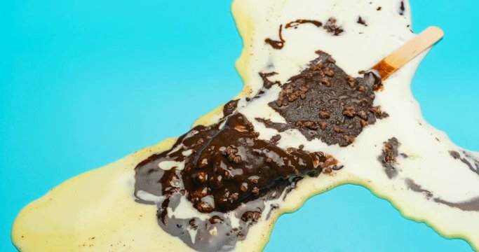 reverse of chocolate outer popsicle with beans melting on blue background time lapse