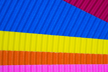 Multi coloured corrugated paper texture, use for background. vivid colour with empty space for add text or object.