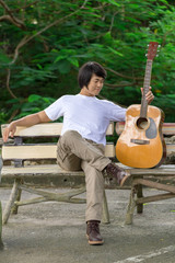 The guy playing the guitar, outdoor, cargo pants