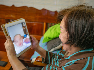 Grandmother use her tablet to talk with her Grandchild