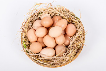 Hen or chicken eggs basket on the hey