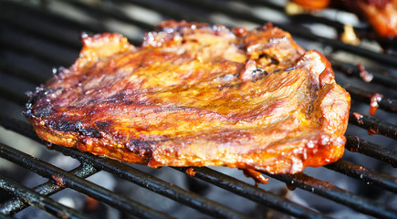 Beef steaks on charcoal grill