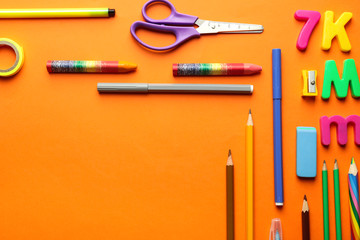 Composition with different school stationery on color background