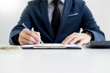 Businessman giving end key to customer after good deal agreement. while loan agreement being approved and calculator, Buy house concept.