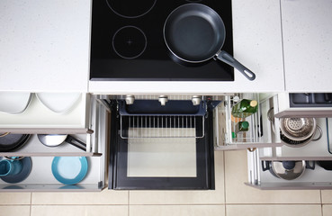 Set of clean kitchenware in drawers