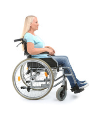 Obraz na płótnie Canvas Mature woman sitting in wheelchair on white background