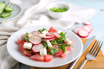 Plate with delicious watermelon salad on table