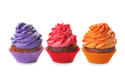 Delicious colorful cupcakes on white background