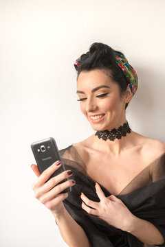 Sensual brunette model with retro ethno look smiling and taking a selfie