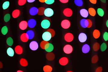 Blurred view of glowing lights on dark background