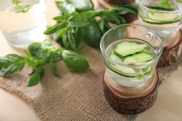 Glass cup of tasty cucumber water on table