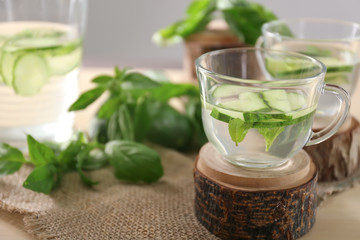 Glass cup of tasty cucumber water on table