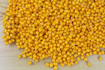 Autumn sea buckthorn lies on a wooden table