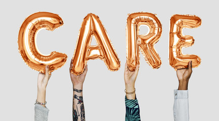Hands showing care balloons word