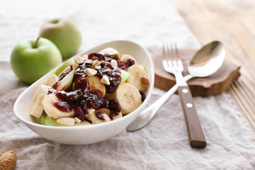 Plate with delicious fruit salad on napkin