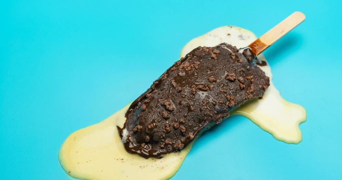 chocolate outer popsicle with beans melting on blue background time lapse and reverse