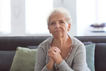 Depressed elderly woman at home