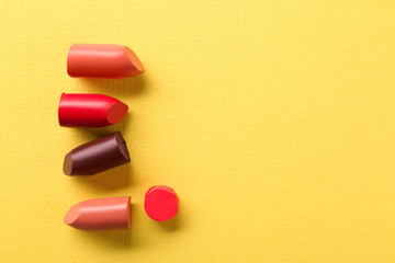 Different lipsticks on color background