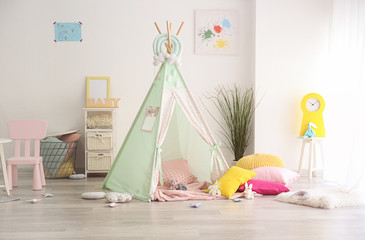 Cozy play tent for kids in interior of room