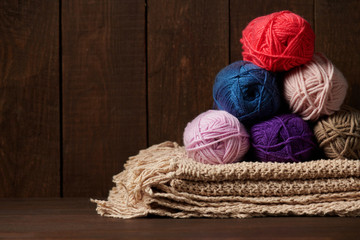 Obraz na płótnie Canvas balls of woolen thread for knitting on wooden background