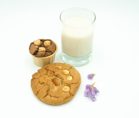 reakfast - milk ,cookie and cupcake   a white background. Selective focus.