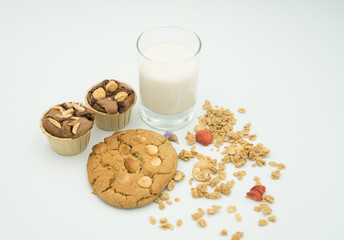 reakfast - milk ,cookie and cupcake   a white background. Selective focus.