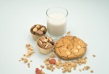 reakfast - milk ,cookie and cupcake   a white background. Selective focus.