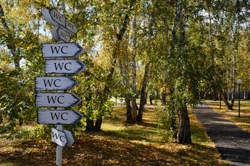 signpost in the park, inscriptions "WC"