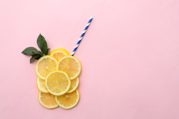 Flat lay composition with lemon slices and straw on color background
