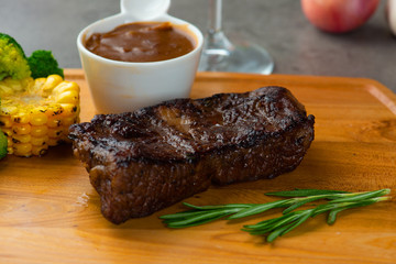 Grilled beef steak with spices on cutting board