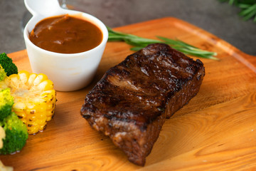 Grilled beef steak with spices on cutting board