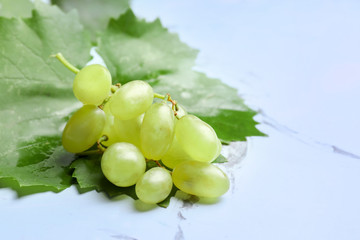 Ripe juicy grapes on light table