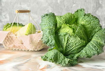 Fresh savoy cabbage on color table