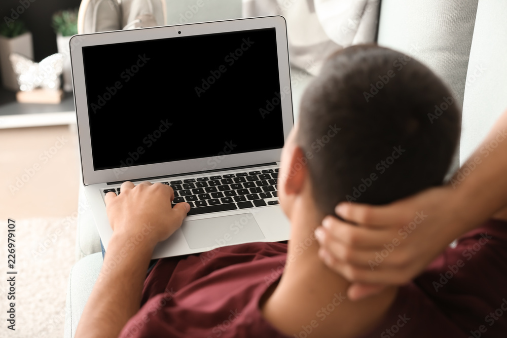 Sticker Young man working with laptop at home