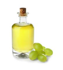 Bottle with grape seed oil on white background