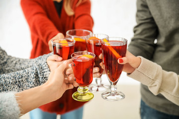 Friends drinking delicious mulled wine at party