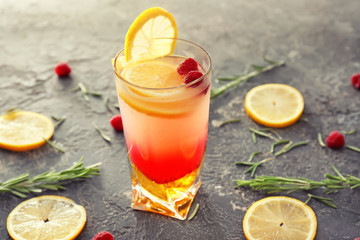 Glass with delicious summer cocktail on table