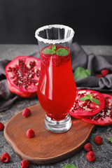 Glass with delicious summer cocktail on table