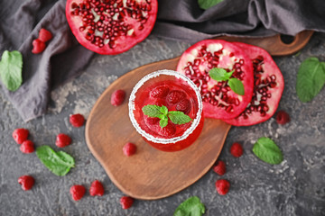 Glass with delicious summer cocktail on table