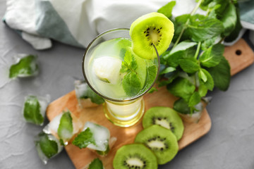 Glass with delicious summer cocktail on table