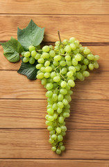 Ripe sweet grapes on wooden background