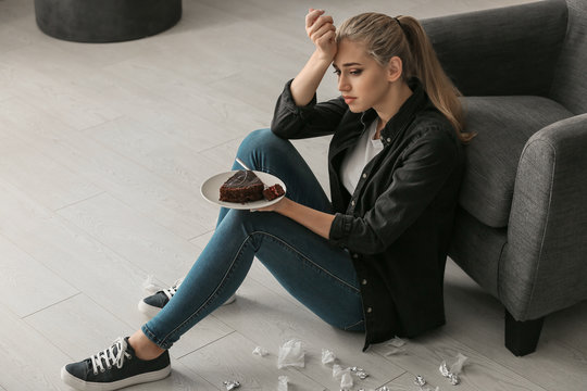 Lonely Depressed Woman Eating Chocolate Cake At Home